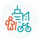 Ανθρώπινο άτομο με μπαστούνι και ποδήλατο μπροστά από κτίρια.